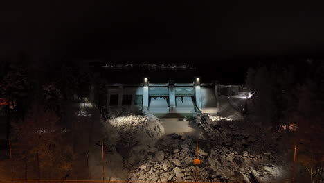 establishing aerial in front of the snowy imatra dam, winter night in finland