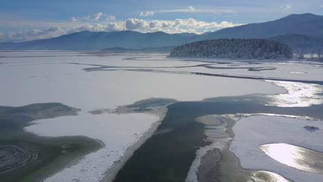 spring ice drift on the frozen winter river lake overflight - drone collection stock video