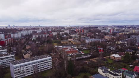 Drone-descending-revealing-industrial-district-of-Riga-in-cloudy-day