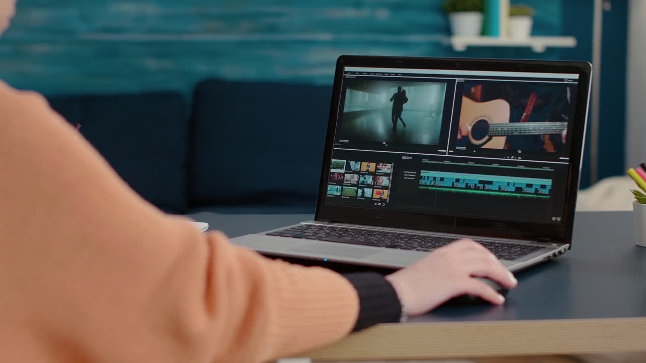 Multimedia designer using software to edit video footage