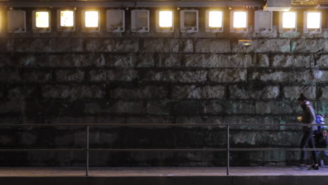 pedestrians walking on the sidewalk in a tunnel