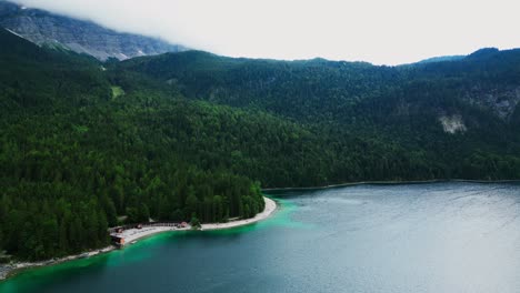 Antena-Del-Lago-Eibsee-En-La-Base-De-La-Montaña-Zugspitze,-Pintoresco-Lago-En-Las-Montañas-Rodeado-De-Un-Bosque-De-Pinos,-Alemania