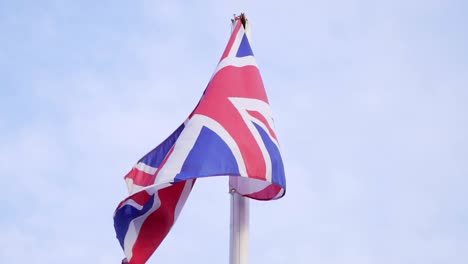 slow motion of the flag of uk on a pole