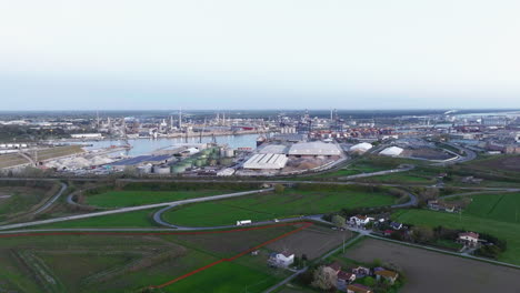 Industrial-and-port-area-of-Ravenna-,chemical-and-petrochemical-pole,thermoelectric,metallurgical-plants-and-hydrocarbon-refinery-and-liquefied-natural-gas-tanks,shot-at-sunrise