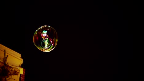 colorful soap bubble art flying in black background