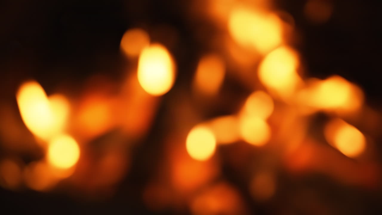 Blurred footage of burning fire with firewood. Red flames