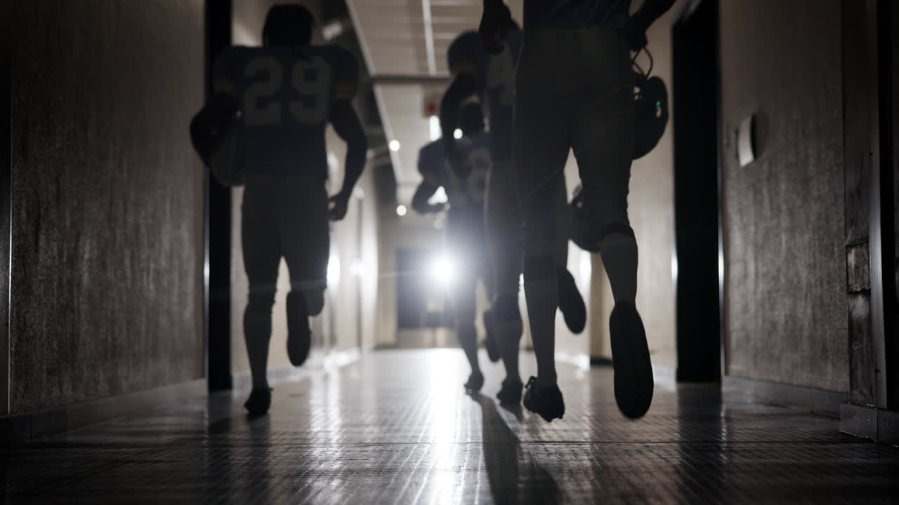 Football players running down hallway