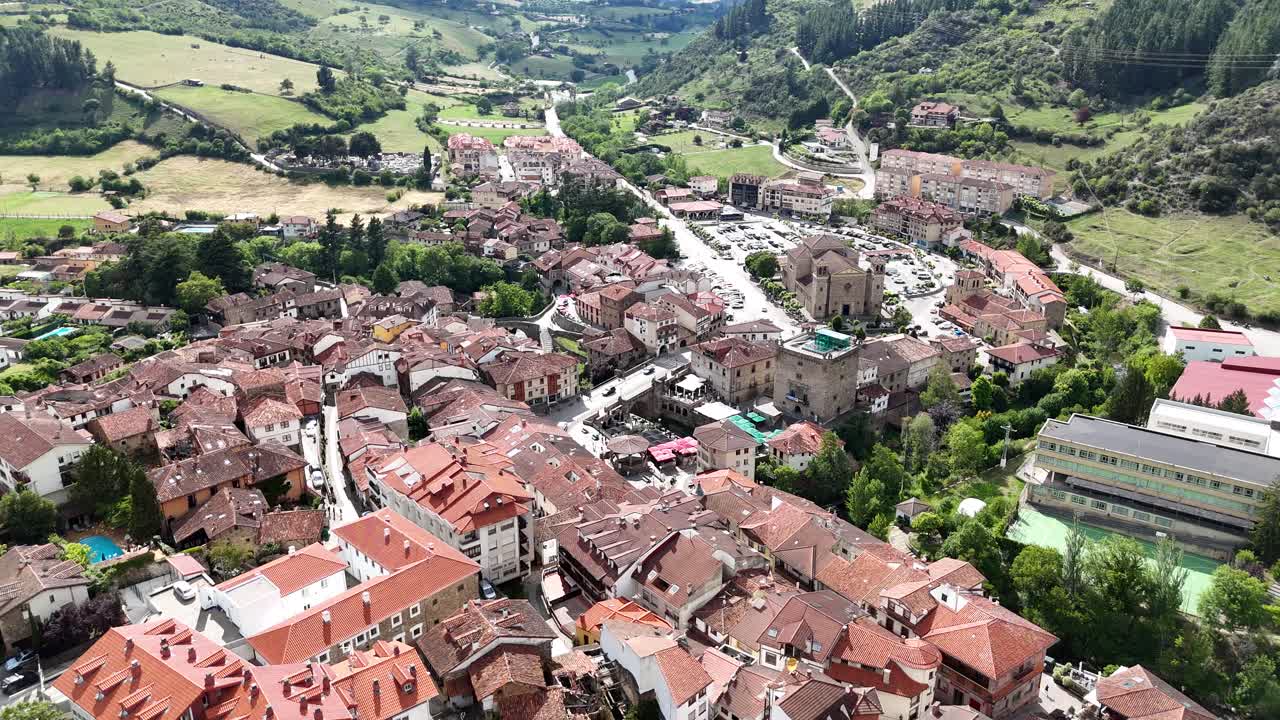 Aerial View of a European Town Nestled in a Lush Green Valley