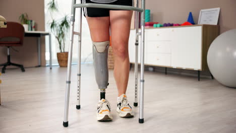 woman using a walker with a prosthetic leg in a physical therapy session