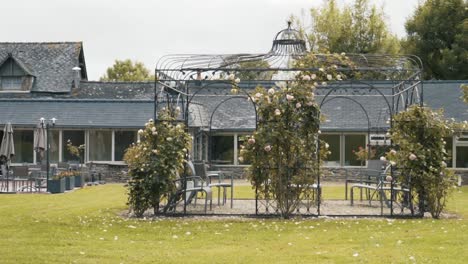 wrought iron gazebo with rose garden