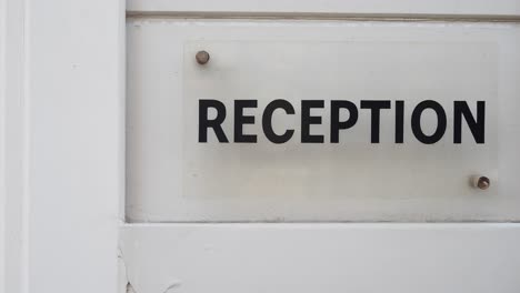 Reception Sign on a White Door