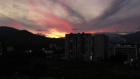 beautiful sunset in the city of ibague in the department of tolima in colombia, you can see beautiful yellow, orange and salmon colors while the drone crosses some buildings.