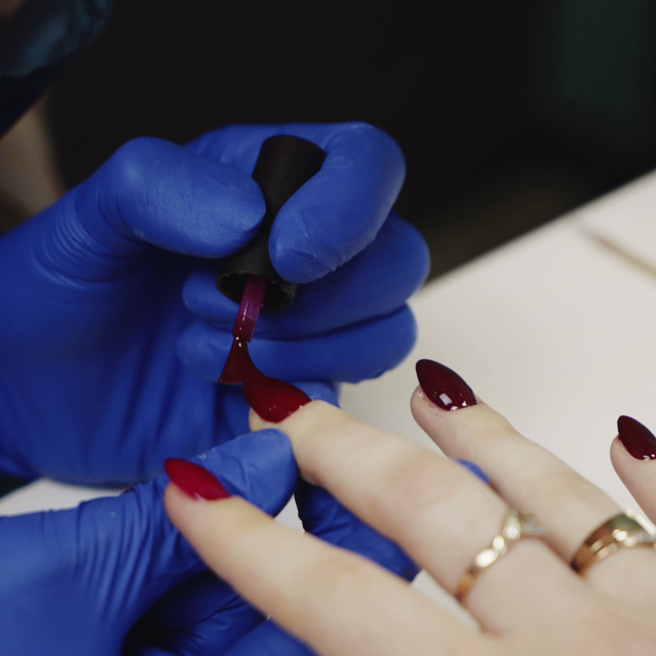 Manicure. Polishing nails with red nail polish in the beauty salon. Hand care in the spa. Close-up Square video