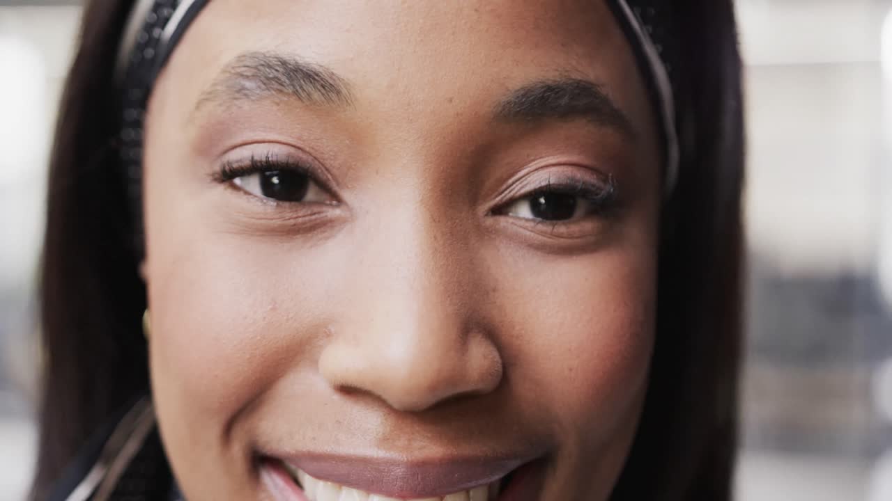 Happy african american casual businesswoman looking up and smiling