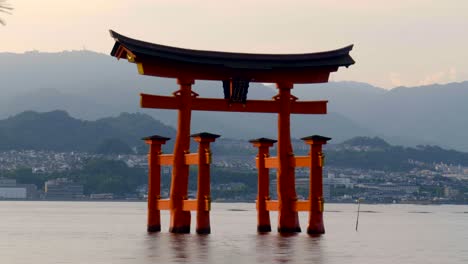 sunset timelapse of great giant red torii of itsukushima shrine temple at miyajima hiroshima japan complety floaded tide inside the temple no tourist people