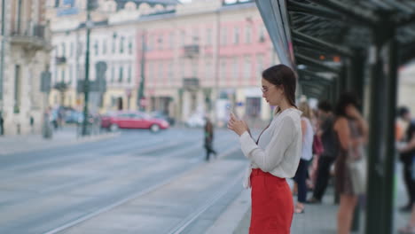 woman waiting at a city bus stop