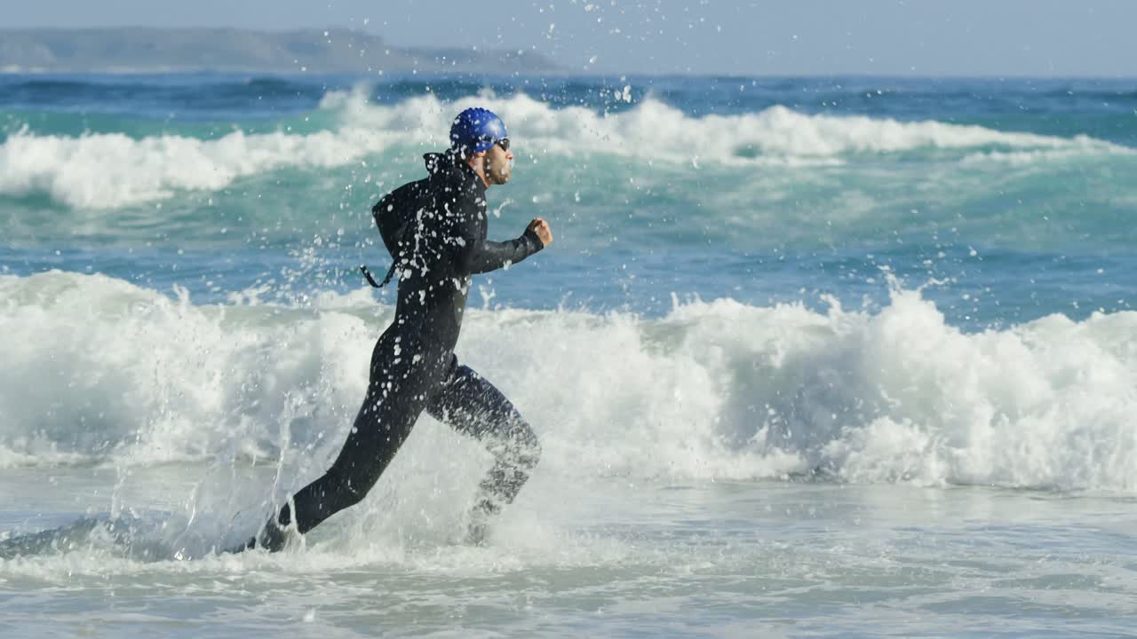 해변에서 뛰고 있는 남성 서퍼