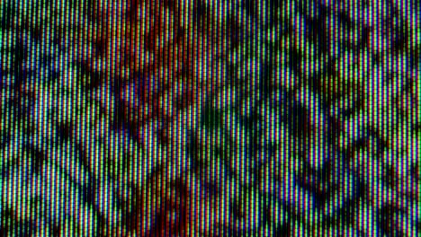 pixels in the working old analog tv screen close up. red, blue and green dot create the image on the screen. macro. close up