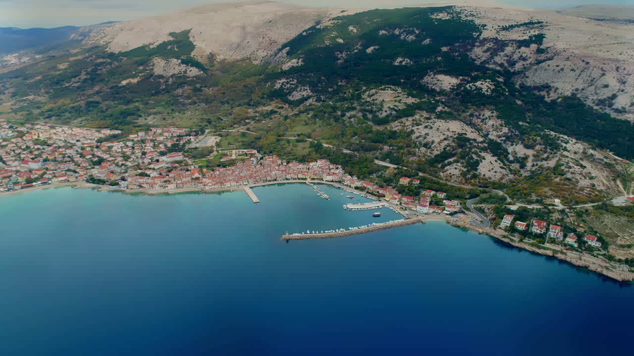 Aerial panning shot of Baska, a popular tourism destination on Krk island, Croatia