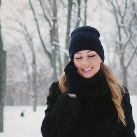 attractive brunette using phone in winter scene