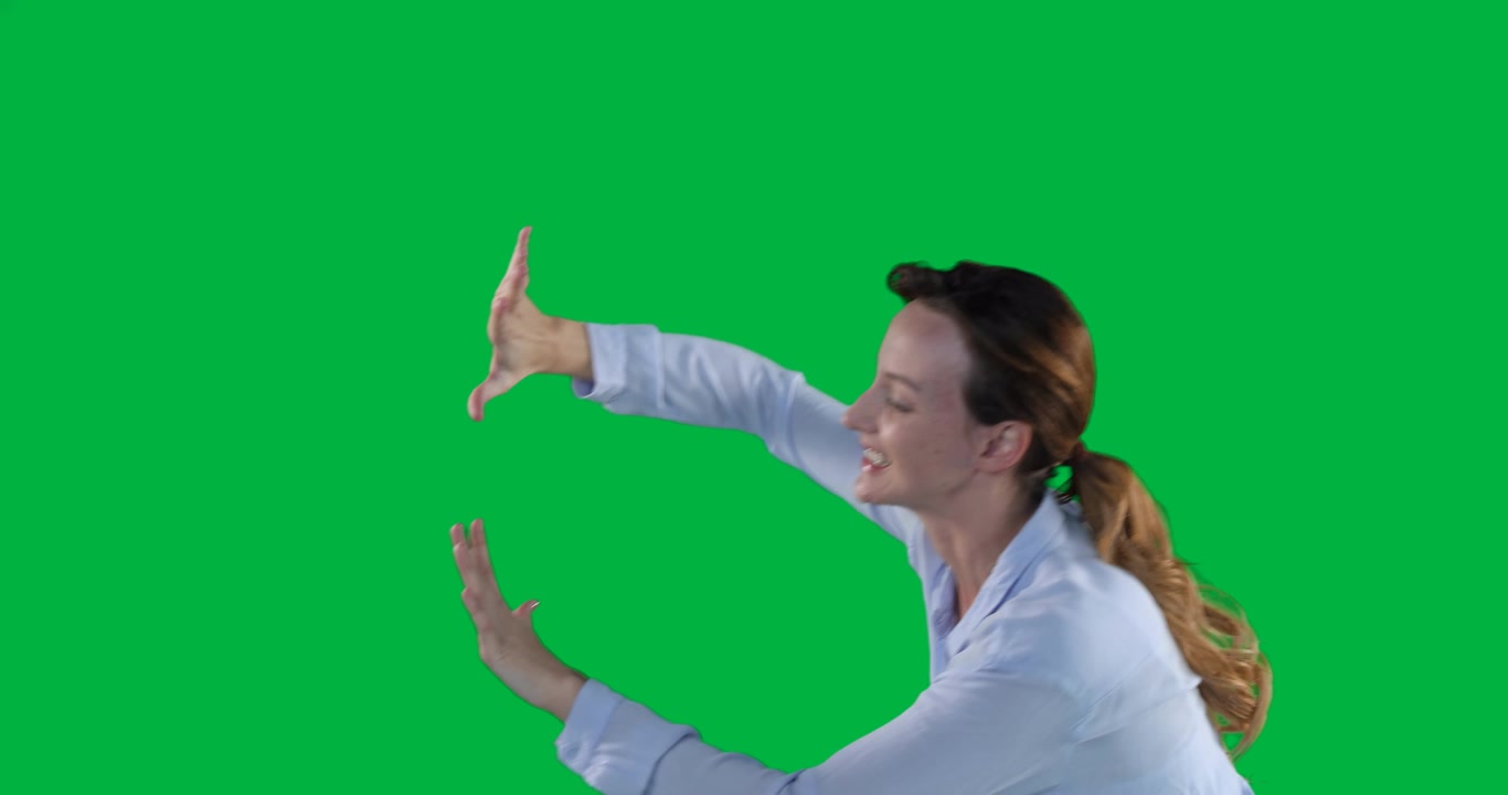 Woman reaching forward on transparent backdrop on camera roll, framing palms for tech overlay