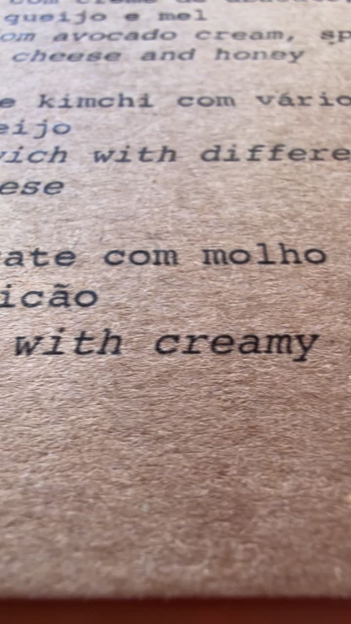 Close-up Panning Across a Textured Restaurant Menu