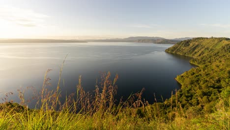 scenic view of a vast lake surrounded by mountains at dawn or dusk