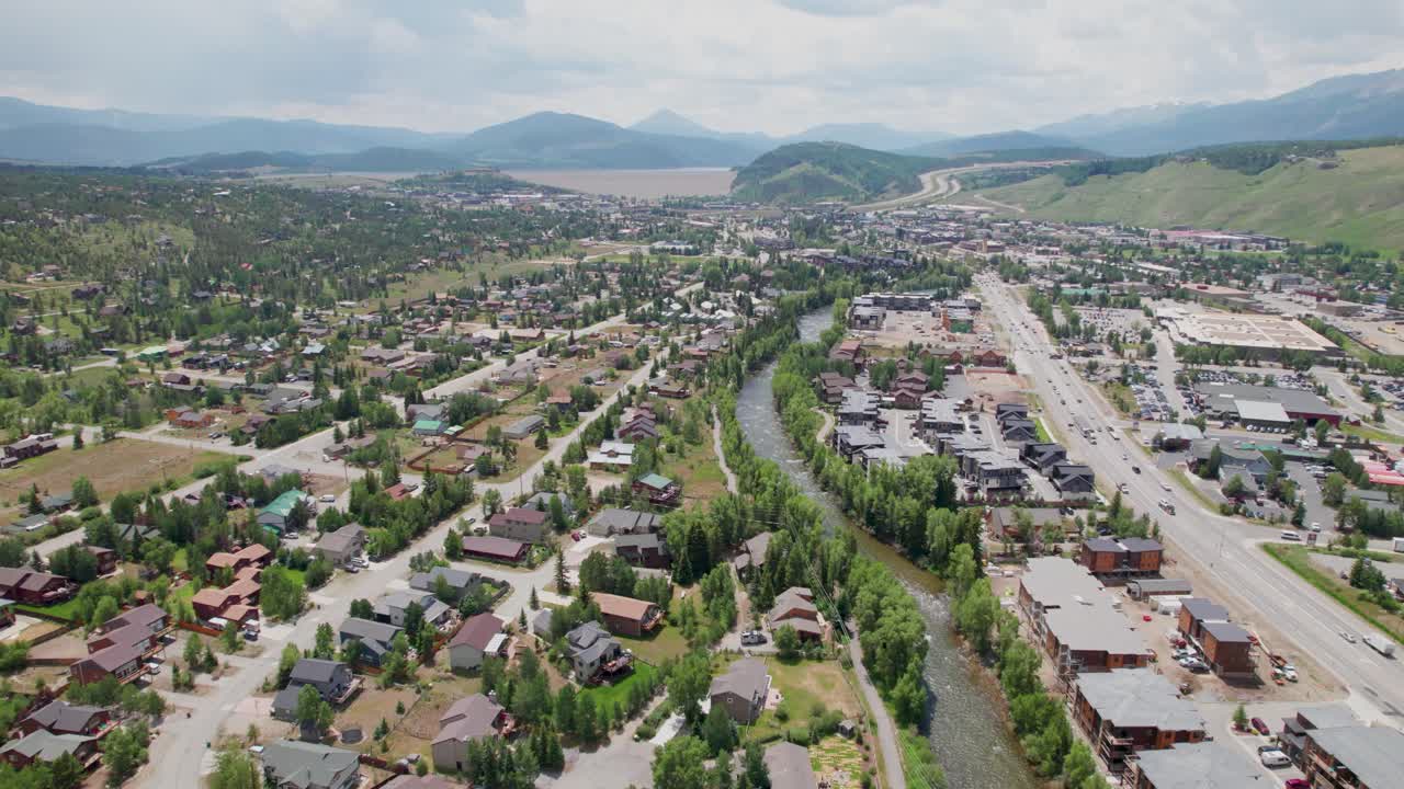 This is a static aerial video of the city of Silverthorne in Colorado. The Blue River is visible as well as part of the city with mountains in the background.