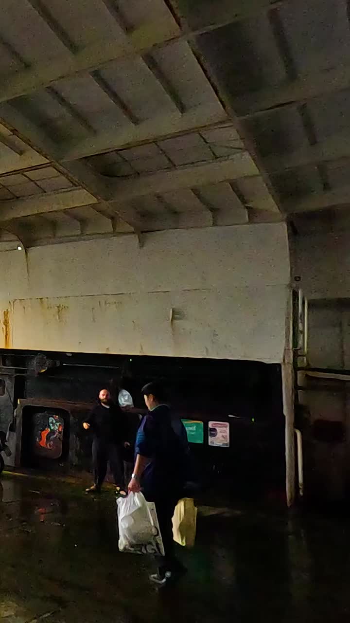 Passengers disembark from ferry onto wet dock