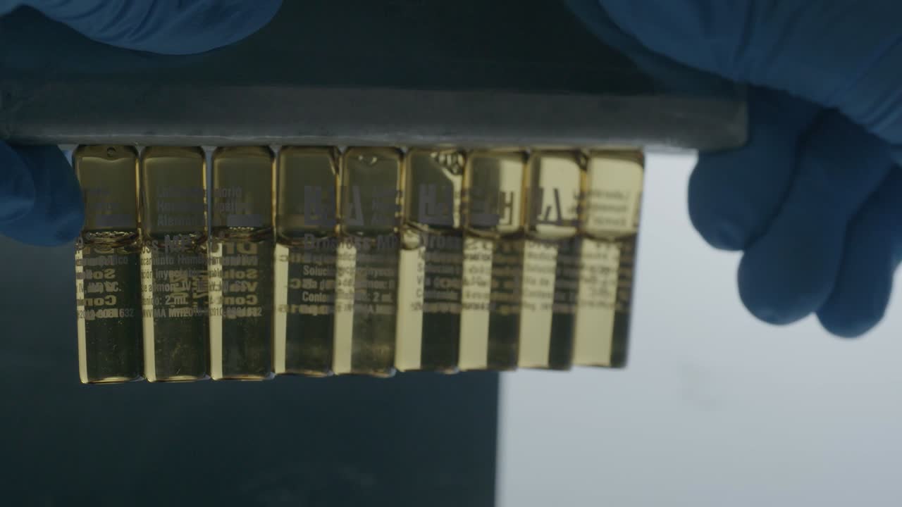 close-up view of a researcher analyzing bottles to ensure they are properly sealed.