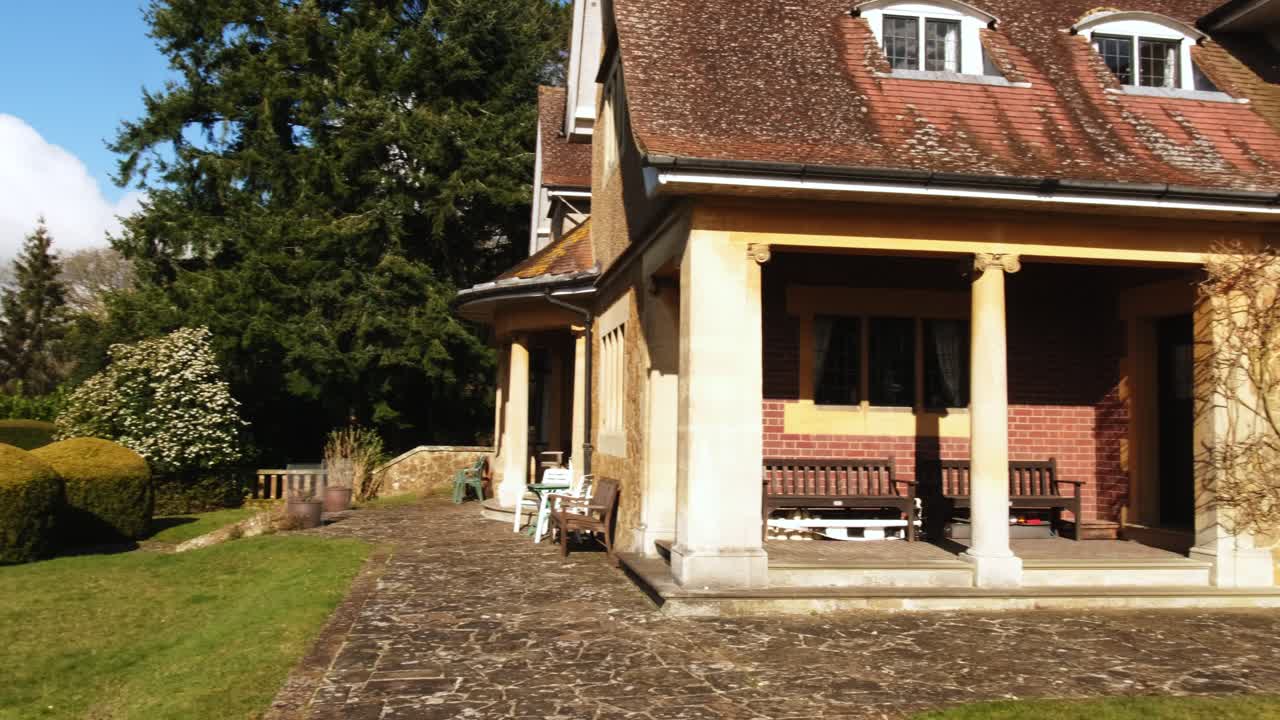 Wide shot pan of Fintry Mansion in Surrey hills during warm summer day