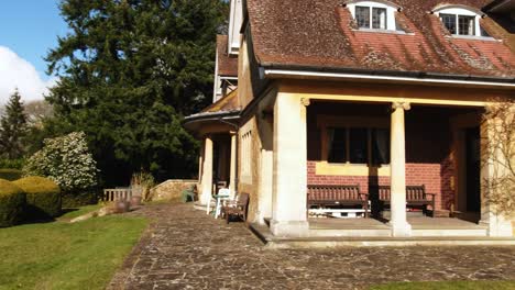 wide shot pan of fintry mansion in surrey hills during warm summer day