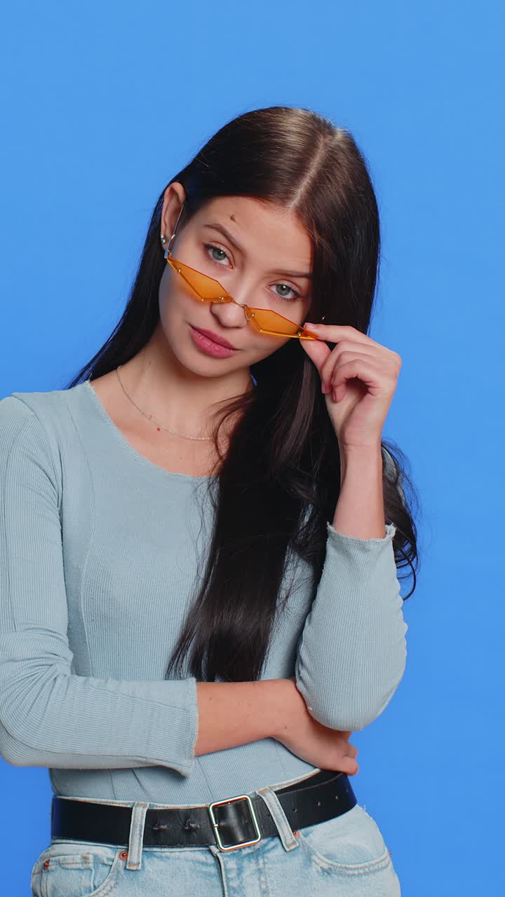 Caucasian young stylish cool woman wearing yellow sunglasses charming friendly playful smile