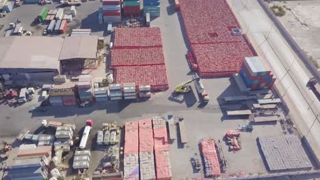 trucks lineup to get loaded with container cargo in a container yard with a cargo lifter forklift