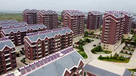 Aerial-gimbal-up-view-of-modern-houses-in-urbanized-residential-complex-in-Nanhai-New-District,-China