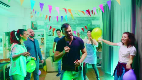 Young-man-holding-a-beer-bottle-at-a-party