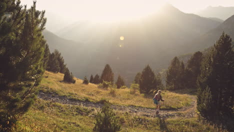 Blonde-woman-hiking-with-trekking-poles,-Benasque,-Spain,-wide-shot-slow-motion