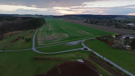 Countryside-Flyover-Svitavy,-Czech-Republic,-With-Cloudy-Sunrise-And-Green-Fields,-4K-Aerial-Drone