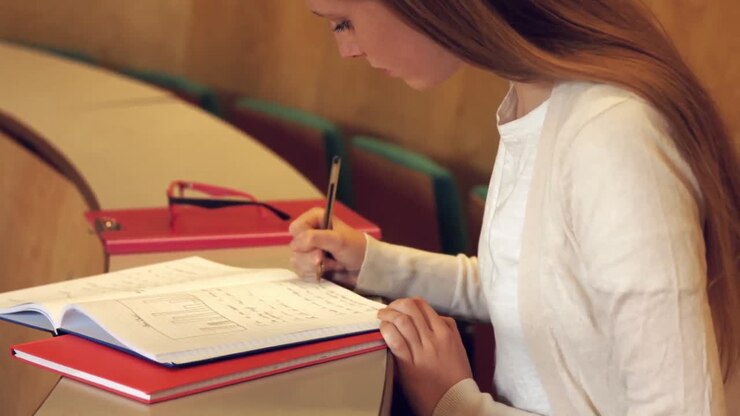 Student taking down notes in class