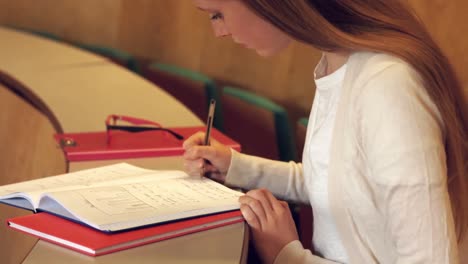 estudiante tomando notas en la clase