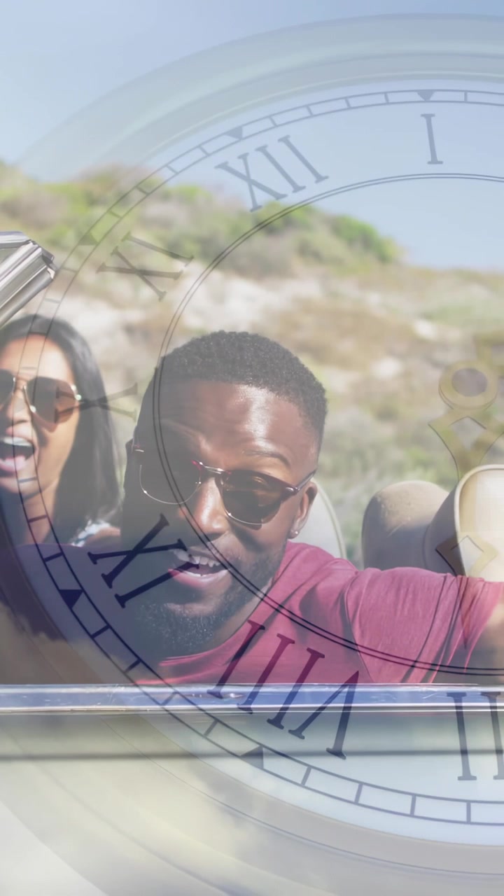 Driver steering and calling, passenger laughing for travel on coastal road, clock overlay framing