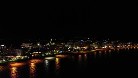 aerial backward over coast of balearic mallorca island at night