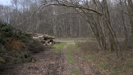 vintage motorcycle drives on a road through winter forest, aerial dolly forward