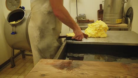 close up of a man at work making butter in a dairy