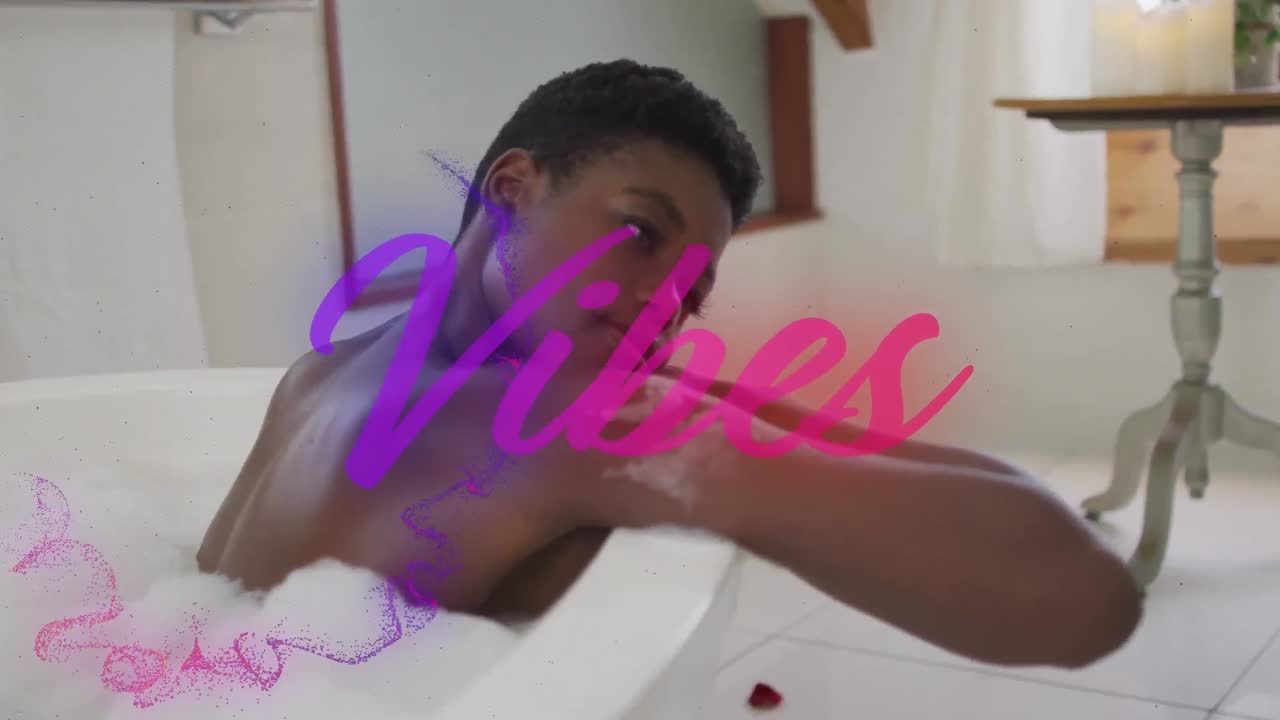 Animation of vibes text in purple over happy african american woman relaxing in bath at home
