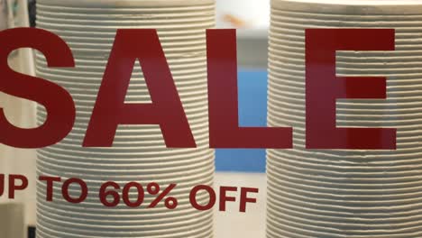 sale sign in store window with up to 60% off