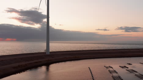 Windturbines-and-aquaculture-during-sunset-on-the-island-Neeltje-Jans,-the-Netherlands