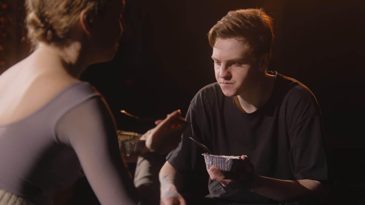 Couple Eating in a Dark Setting