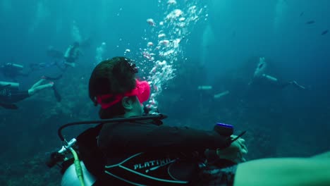 underwater scuba diving adventure with a pink mask