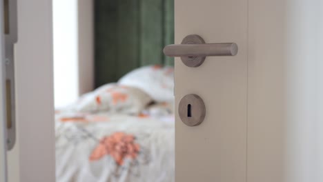 closeup of a white door with a silver door handle